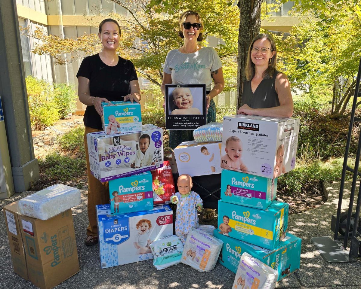 Picture of JJC members with lots of diapers and wipes